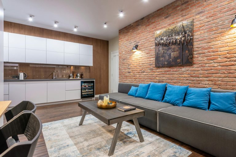 Modern loft room and kitchen interior with furniture and artwork